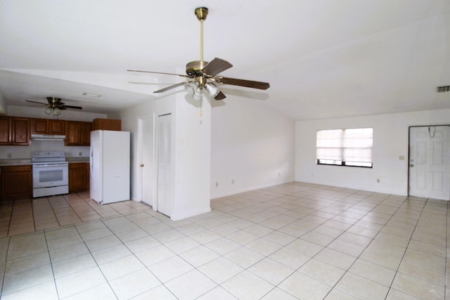 1561 SE Arenson Ln, Port Saint Lucie, FL 34952 - unfurnished living room with ceiling fan, light tile patterned flooring, and lofted ceiling