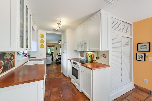 1228 George Bush Blvd Unit 4, Delray Beach, FL 33483 - kitchen featuring white appliances, a sink, white cabinetry, and dark tile patterned floors