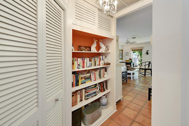 1228 George Bush Blvd Unit 4, Delray Beach, FL 33483 - hallway with tile patterned flooring and a chandelier