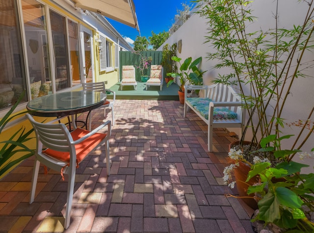 1228 George Bush Blvd Unit 4, Delray Beach, FL 33483 - view of patio featuring fence and outdoor dining area