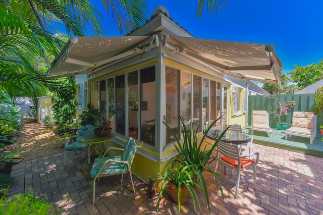 1228 George Bush Blvd Unit 4, Delray Beach, FL 33483 - deck featuring a patio, fence, and a sunroom