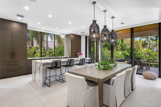 dining space featuring light tile patterned floors, floor to ceiling windows, and recessed lighting