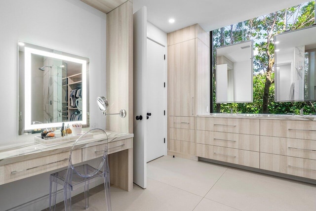 full bathroom with vanity and a spacious closet