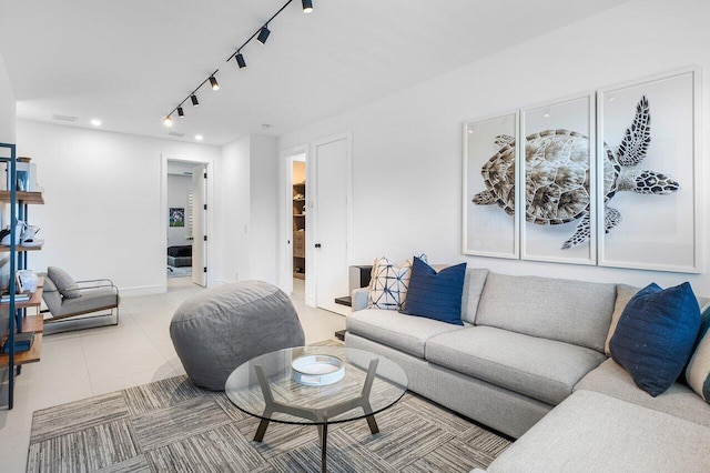 living area featuring track lighting, recessed lighting, light tile patterned floors, and baseboards