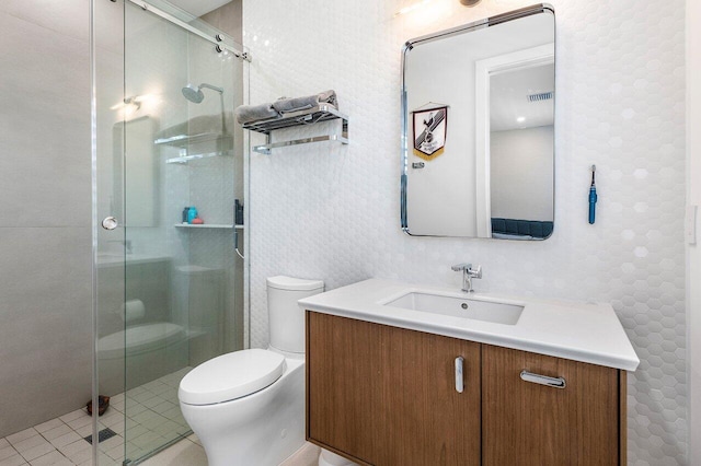full bath featuring a stall shower, toilet, vanity, and tile patterned flooring