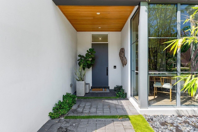property entrance with stucco siding