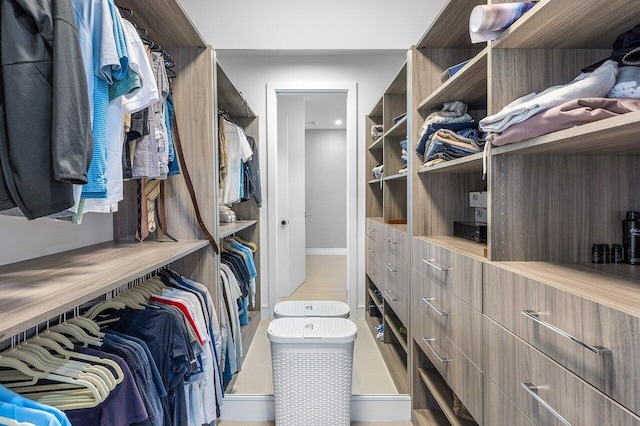 spacious closet with tile patterned floors