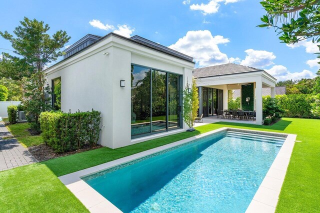 outdoor pool featuring a yard, a gazebo, and a patio area
