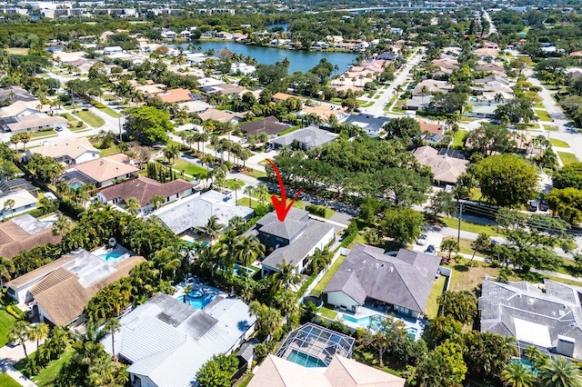 aerial view of property's location featuring nearby suburban area and a large body of water