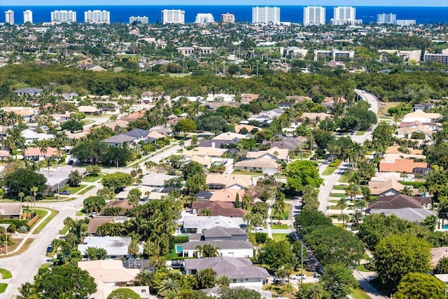 aerial view of property's location with nearby urban area and a nearby body of water