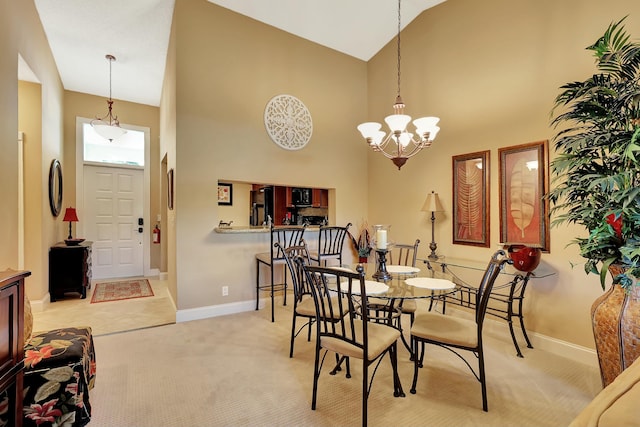 212 Cypress Point Dr, Palm Beach Gardens, FL 33418 - dining area with high vaulted ceiling, a chandelier, baseboards, and light carpet