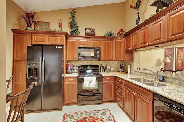 212 Cypress Point Dr, Palm Beach Gardens, FL 33418 - kitchen with black appliances, a sink, decorative backsplash, light stone counters, and light tile patterned floors