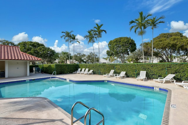 212 Cypress Point Dr, Palm Beach Gardens, FL 33418 - community pool with a patio area and fence