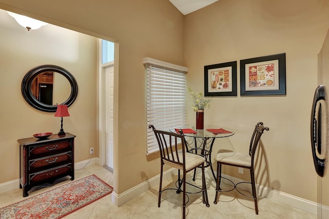 212 Cypress Point Dr, Palm Beach Gardens, FL 33418 - dining room featuring baseboards and a towering ceiling