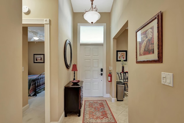 212 Cypress Point Dr, Palm Beach Gardens, FL 33418 - entrance foyer featuring baseboards, light tile patterned floors, and ceiling fan
