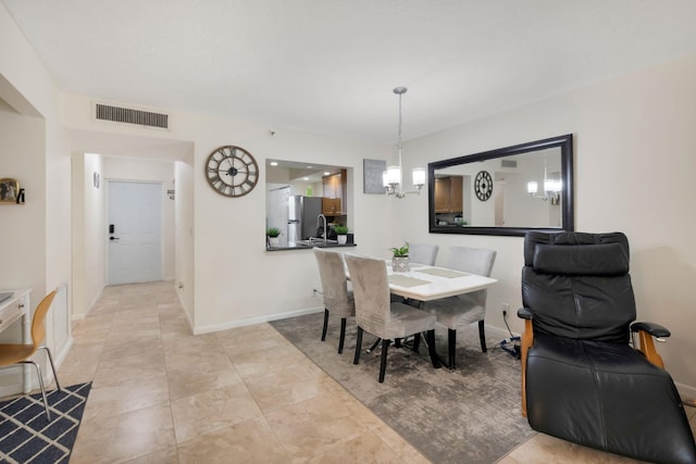 2070 Homewood Blvd Unit 1115, Delray Beach, FL 33445 - dining room featuring a chandelier and baseboards