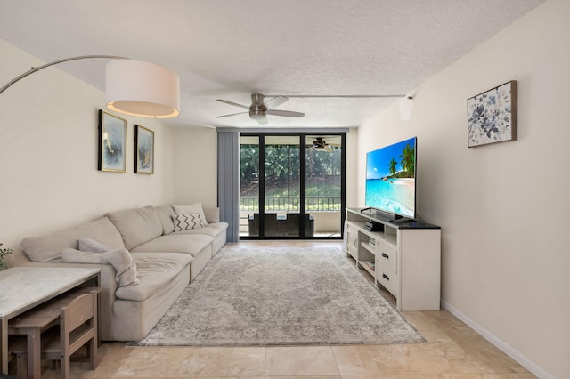 2070 Homewood Blvd Unit 1115, Delray Beach, FL 33445 - living area with expansive windows, ceiling fan, a textured ceiling, and baseboards