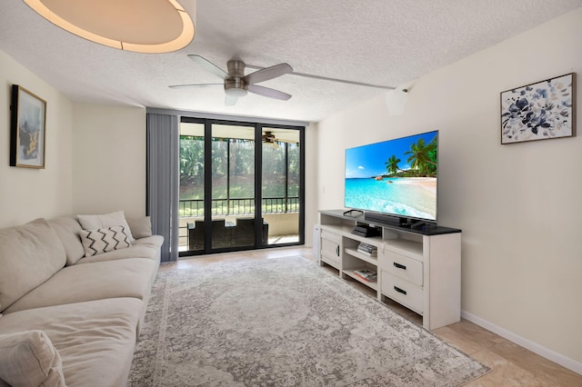 2070 Homewood Blvd Unit 1115, Delray Beach, FL 33445 - living area with ceiling fan, floor to ceiling windows, a textured ceiling, and baseboards