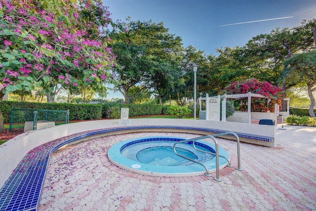 2070 Homewood Blvd Unit 1115, Delray Beach, FL 33445 - view of swimming pool featuring a hot tub and fence