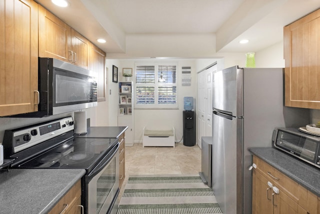 2070 Homewood Blvd Unit 1115, Delray Beach, FL 33445 - kitchen featuring stainless steel appliances, recessed lighting, dark countertops, and light tile patterned floors