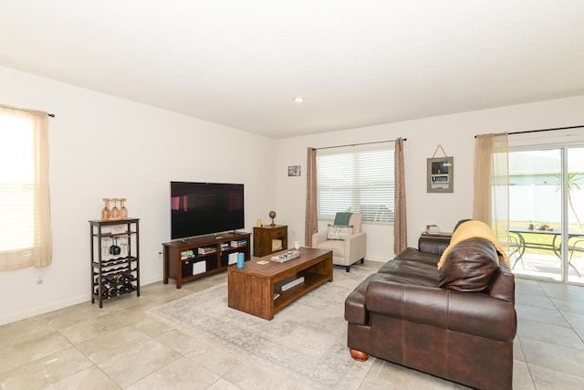 567 SW Paar Dr, Port Saint Lucie, FL 34953 - living area featuring light tile patterned flooring, plenty of natural light, and baseboards