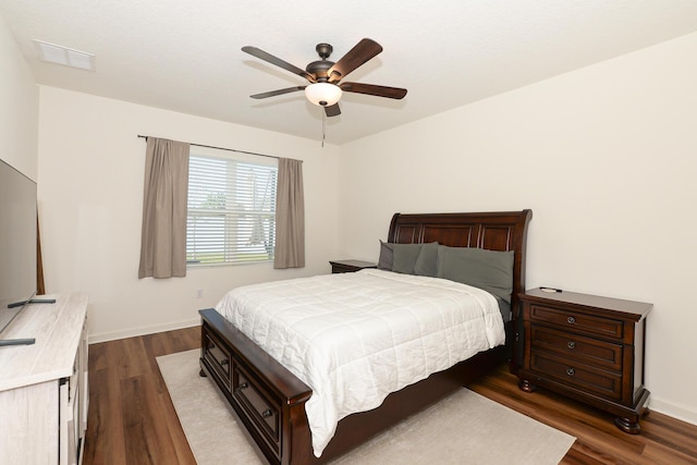 567 SW Paar Dr, Port Saint Lucie, FL 34953 - bedroom with dark wood-style floors, baseboards, and a ceiling fan
