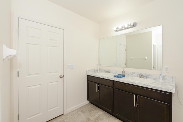567 SW Paar Dr, Port Saint Lucie, FL 34953 - bathroom with double vanity and baseboards