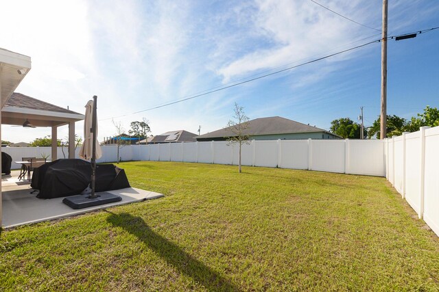 567 SW Paar Dr, Port Saint Lucie, FL 34953 - view of yard with a patio area