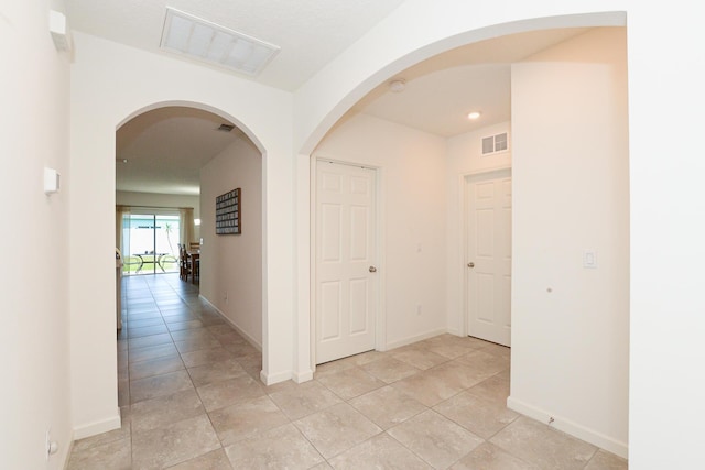 567 SW Paar Dr, Port Saint Lucie, FL 34953 - hallway with baseboards, light tile patterned flooring, and recessed lighting
