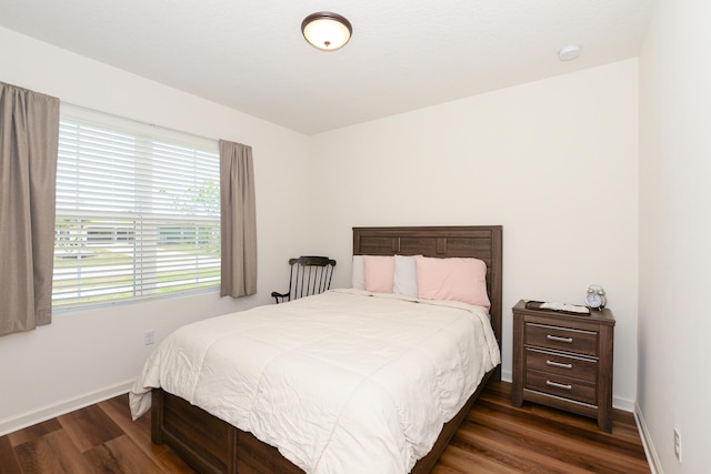 567 SW Paar Dr, Port Saint Lucie, FL 34953 - bedroom with dark wood-style flooring and baseboards