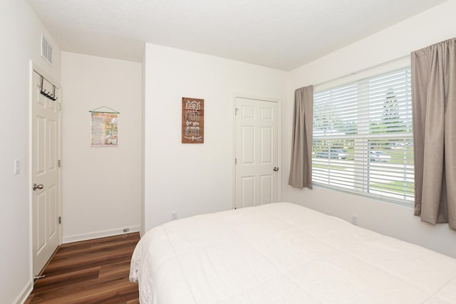 567 SW Paar Dr, Port Saint Lucie, FL 34953 - bedroom featuring dark wood-type flooring and baseboards