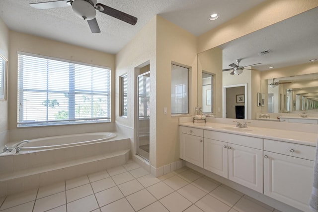 full bath featuring a ceiling fan, a garden tub, a shower stall, tile patterned flooring, and vanity