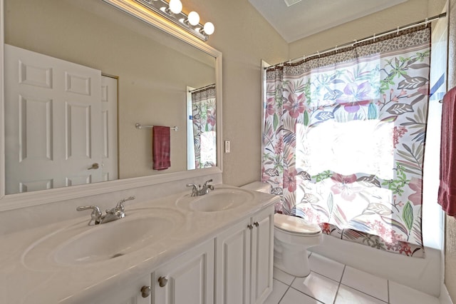 full bathroom featuring toilet, double vanity, and tile patterned floors