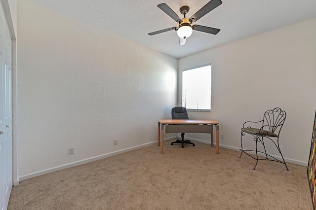 office area with carpet, baseboards, and ceiling fan