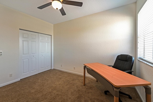 office space with a ceiling fan, carpet floors, a textured wall, and baseboards