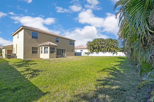 back of property with stucco siding and central AC unit