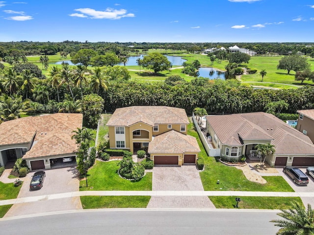 aerial view of property and surrounding area featuring a large body of water and a golf club