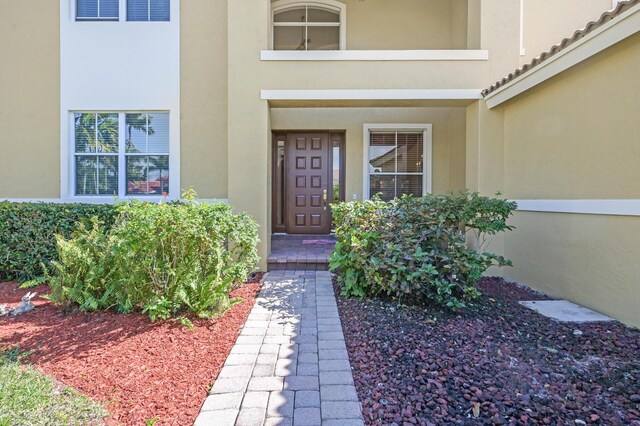 property entrance with stucco siding
