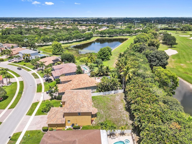 aerial view of a large body of water, a golf club, and a tree filled landscape
