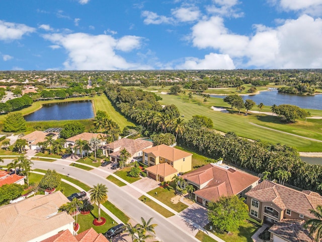 aerial perspective of suburban area featuring a large body of water and a golf course