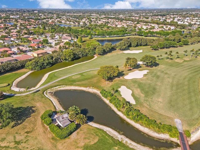 aerial overview of property's location featuring a large body of water, nearby suburban area, and a golf course