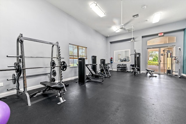 workout area featuring baseboards and ceiling fan