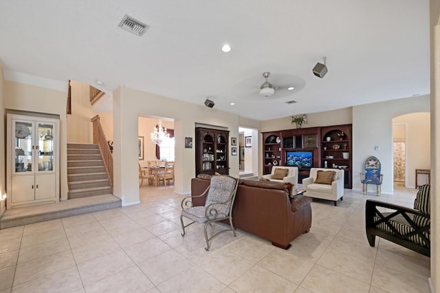 living room featuring stairway, ceiling fan, light tile patterned flooring, arched walkways, and recessed lighting