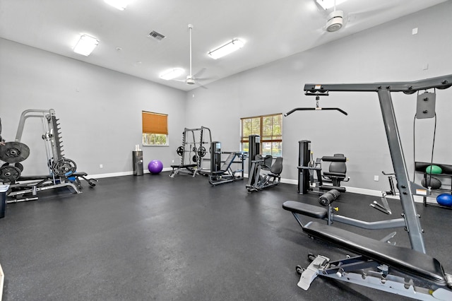 workout area with healthy amount of natural light, baseboards, and ceiling fan
