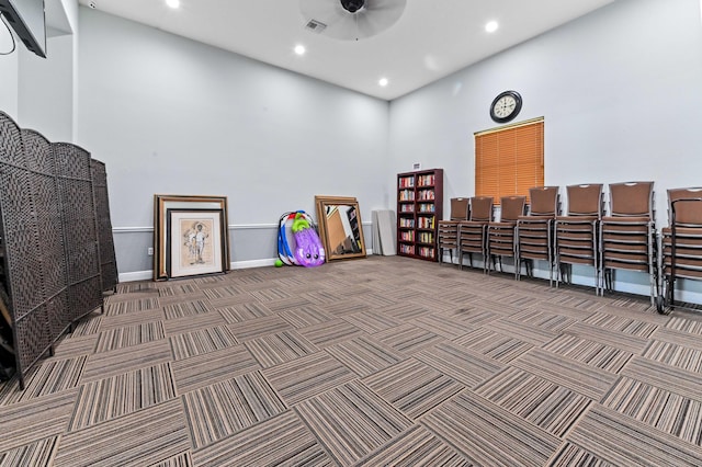 miscellaneous room with carpet flooring, a high ceiling, baseboards, recessed lighting, and a ceiling fan