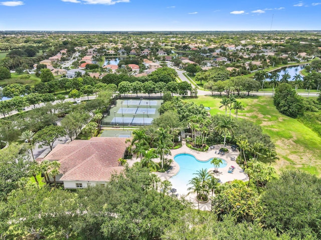aerial view of residential area with a nearby body of water and a pool