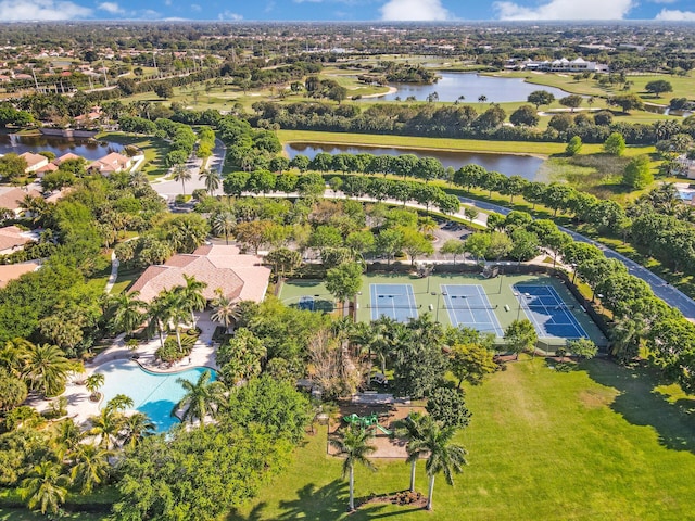 aerial view of property's location featuring a large body of water and nearby suburban area