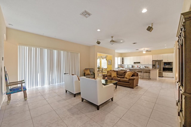 living room featuring light tile patterned flooring, recessed lighting, and ceiling fan
