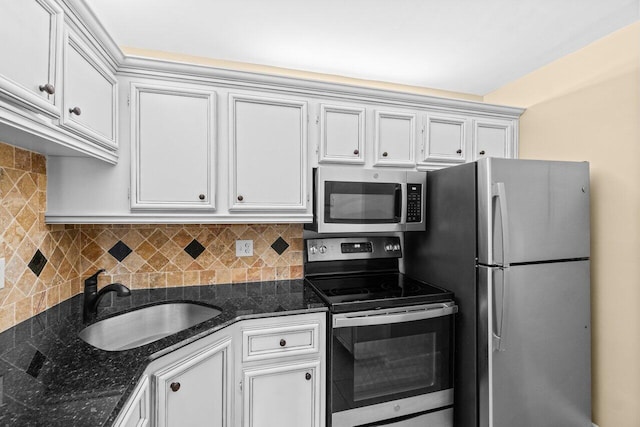 629 Sea Pine Way Unit D1, Greenacres, FL 33415 - kitchen with appliances with stainless steel finishes, a sink, decorative backsplash, and dark stone countertops
