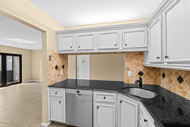 629 Sea Pine Way Unit D1, Greenacres, FL 33415 - kitchen with stainless steel dishwasher, a sink, backsplash, light tile patterned flooring, and dark stone countertops